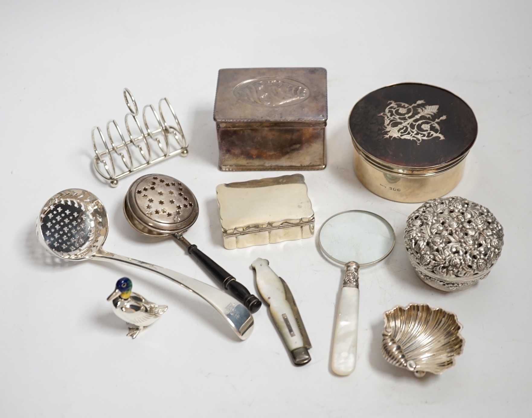 Sundry small silver and white metal including a George IV Old English pattern sifter spoon, later heart shaped five bar toast rack, seven assorted boxes, a vets case and twenty two other items.